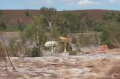 A Pilbara truck driver is lucky to be alive after his truck was swept off a road by flood waters. 