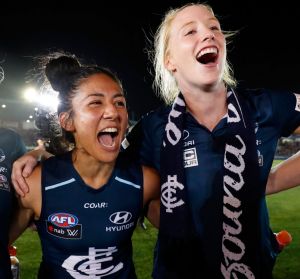 Darcy Vescio of the Blues (middle) sings the team song after the game.