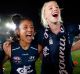 Darcy Vescio of the Blues (middle) sings the team song after the game.