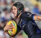 Star on the rise: Kalyn Ponga looks to break the tackle of Paul Roache on day one of the Auckland Nines.