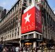 Pedestrians and shoppers pass in front of a Macy's flagship store in New York.