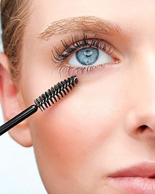 Woman with two mascara brushes