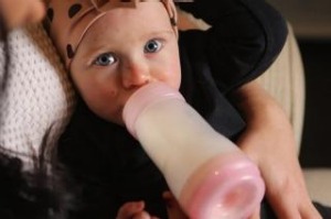 Tara Lloyd feeds her 8-month-old daughter Gracie Perkin a2 Platinum infant formula.