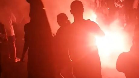 A flare is lit at the Melbourne derby on Saturday night.