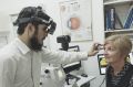 Optometrist Khyber Alam with a patient.