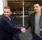 Ammar Alnajjar, left, shakes hands with his cousin, Fahd Alfakih, after coming into New York's JFK International Airport on a flight from Istanbul, Turkey, Saturday, Feb. 4, 2017. The government on Saturday suspended enforcement of President Donald Trump's refugee and immigration ban, enabling Alnajjar to return from Turkey where he was visiting his wife. (AP Photo/William Mathis)