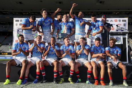 Top of the world: The Roosters squad celebrate after their Nines championship.