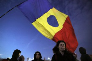 A girl waves a Romanian flag during a protest in Bucharest, Romania, Friday - Romania's political crisis is deepening over a government decree that may benefit rich and powerful people convicted of corruption