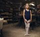 Eight-year-old Alexandra Shaw  in the factory behind Salvios Dancing Shoes, in Randwick, with Phil Salvio toiling in the ...