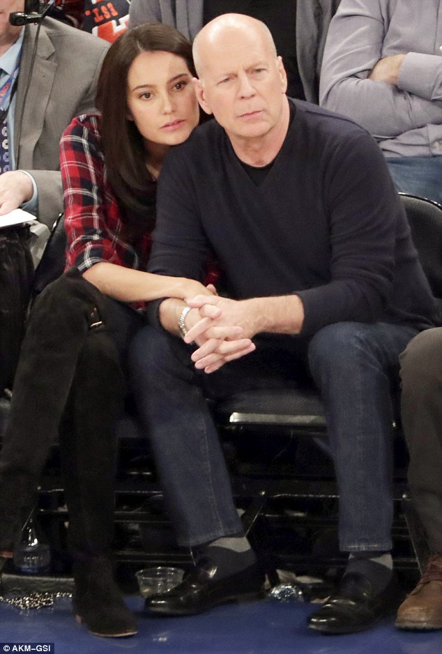 High spirits: In jovial spirits throughout the evening, he completed his low-key ensemble with a statement silver watch, watching the game intently