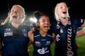 Darcy Vescio of the Blues (left) sings the team song after the game.