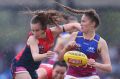 Brisbane's Tahlia Randall clashes with Sarah Lampard of the Demons at Casey Fields.