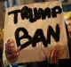 A man holds a placard during a gathering in Paris to protest US President Donald Trump's recent travel ban.