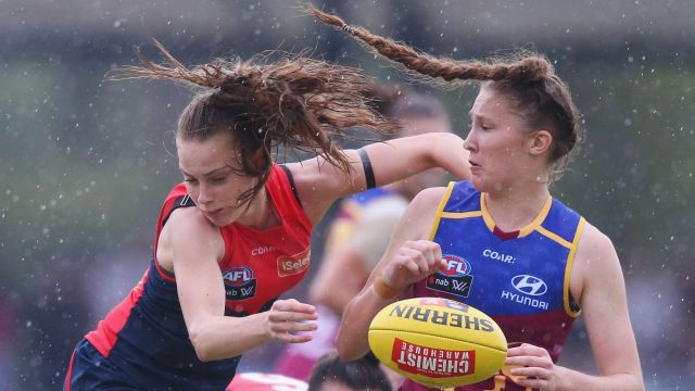 Brisbane's Tahlia Randall clashes with Sarah Lampard of the Demons at Casey Fields.