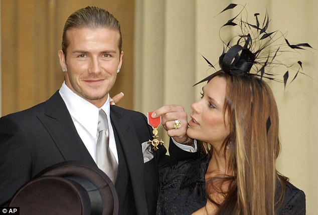 David Beckham poses with Victoria at Buckingham Palace after he was appointed OBE in 2003