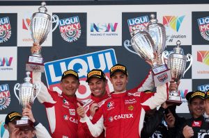 Controlled aggression: Toni Vilander, Craig Lowndes and Jamie Whincup celebrate the win.
