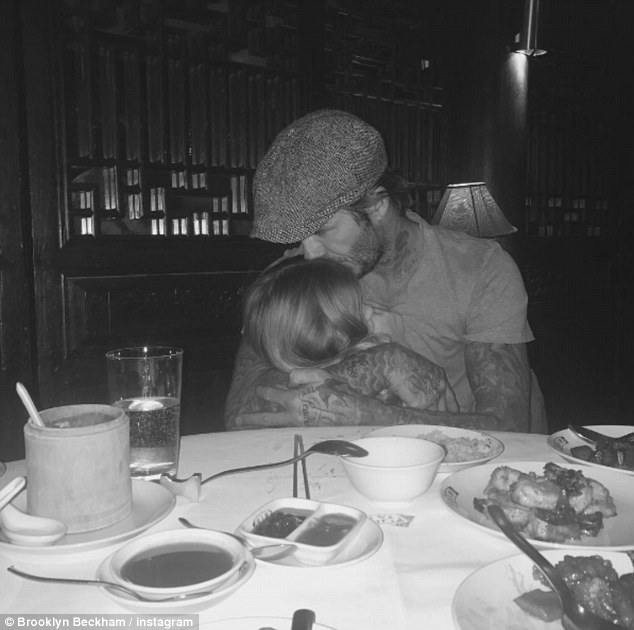 Damage control: It appears David Beckham is on damage control as his 17-year-old son Brooklyn shared a candid moment of his former footballer father placing a sweet kiss on four-year-old Harper's head on Instagram