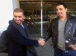 Ammar Alnajjar, left, shakes hands with his cousin, Fahd Alfakih, after coming into New York's JFK International Airport on a flight from Istanbul, Turkey, Saturday, Feb. 4, 2017. The government on Saturday suspended enforcement of President Donald Trump's refugee and immigration ban, enabling Alnajjar to return from Turkey where he was visiting his wife. (AP Photo/William Mathis)