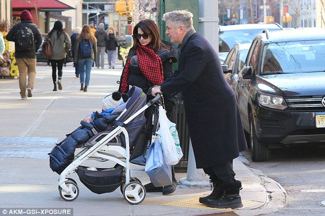 Out for a walk: It stands to reason that Alec Baldwin found himself multitasking at the weekend when he went for a family stroll around New York City with some of his brood
