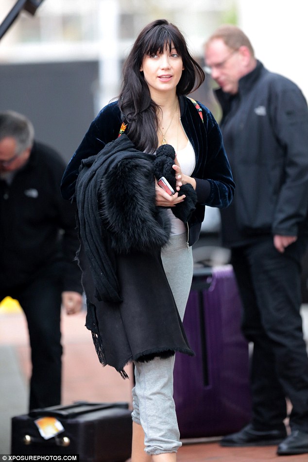 All smiles: Carting her cases out of the hotel, the 28-year-old model was all smiles as she and her fellow dancers prepared to get to work ahead of the evening's show