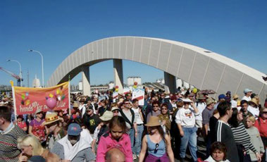 people walking across a bridge