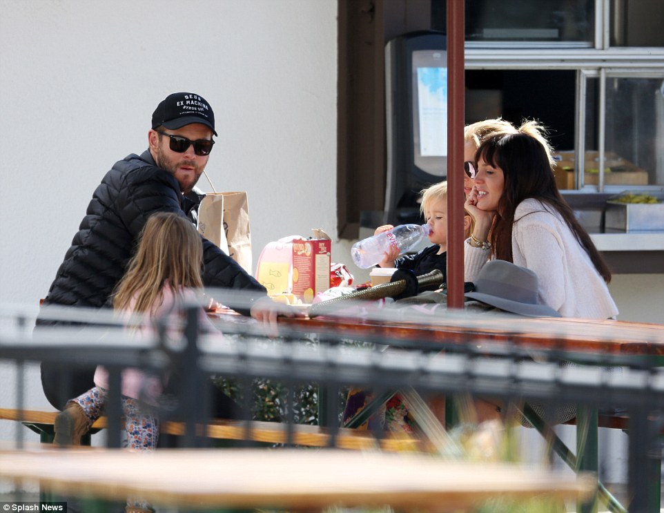 A-list: Aussie heartthrob Chris cut a cool figure in a black cap and shades which he wore with a white tee and a black jacket for a coordinated finish