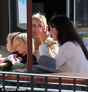 Getting along famously: Elsa's twins Sasha and Tristan sat on her lap and sipped from a bottle of water as the two friends chatted away