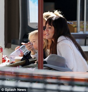 Getting along famously: Elsa's twins Sasha and Tristan sat on her lap and sipped from a bottle of water as the two friends chatted away