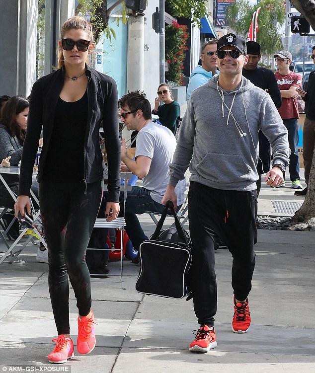 Such a gent: Ryan Seacrest toted a large bag when he and old flame Shayna Taylor turned up to an LA gym together on Saturday, adding to rumours that they are now a couple again 