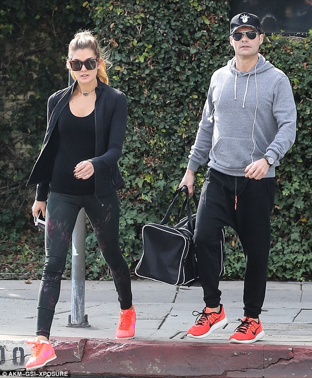 In step: The 42-year-old  former American Idol host and radio and TV personality and the 41-year-old model and personal trainer both wore neon pink sneakers