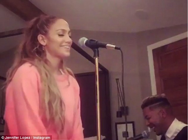 Keeping it happy: Jennifer Lopez shared two videos to her Instagram page on Sunday that show her singing the iconic Nat King Cole hit 'Smile'