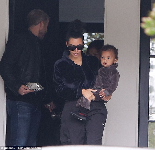 Baby boy: Kim carries Saint out of the house