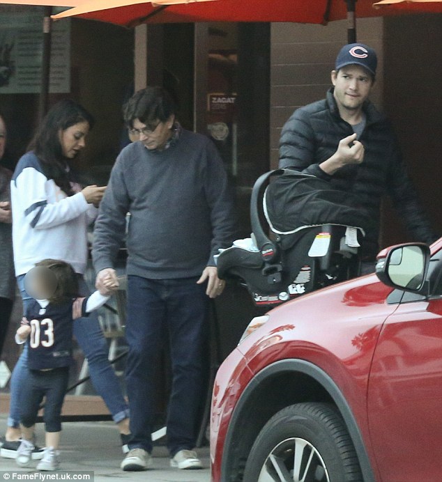 Not taking sides: Ashton Kutcher and Mila Kunis' daughter Wyatt wears football jersey for family breakfast on Super Bowl Sunday 