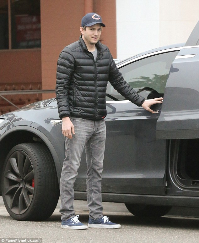 Casual day: The 38-year-old actor donned a Bears baseball cap and looked laid-back in grey slim-fit jeans and a black puffer jacket and trainers