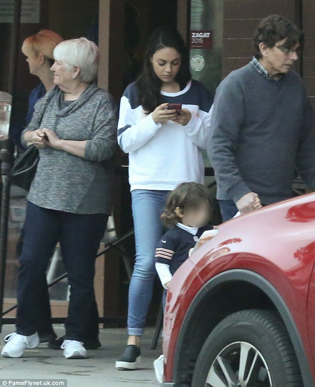 Family brunch: Mila was busy on her cell phone while little Wyatt was seen holding her grandfather's hand