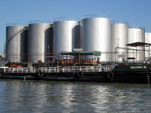 Oil depot silver containers located by the river.