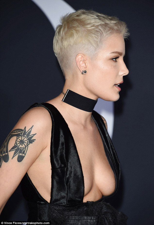 Simply the breast: The edgy blonde singer accessorized her low-cut look with a thick black chocker necklace