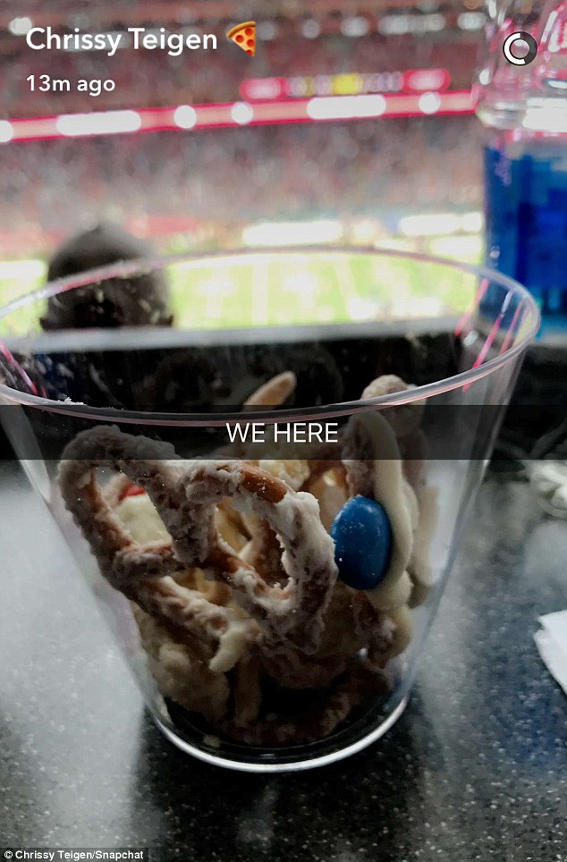 Snacks and snaps: Teigen uploaded this shot of her vantage point from the big game in Houston on Sunday