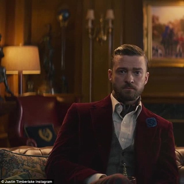 Eye-candy: He is seen wearing a wine red smoking jacket, and waistcoat complete with watch-chain, as he lounges in a classically decorated drawing room