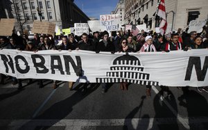 Protesters march from Lafayette Park near the White House in Washington, Saturday, Feb. 4, 2017, during a rally protesting the immigration policies of President Donald Trump.