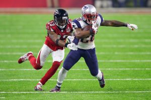 HOUSTON, TX - FEBRUARY 05: James White #28 of the New England Patriots is tackled by Robert Alford #23 of the Atlanta ...