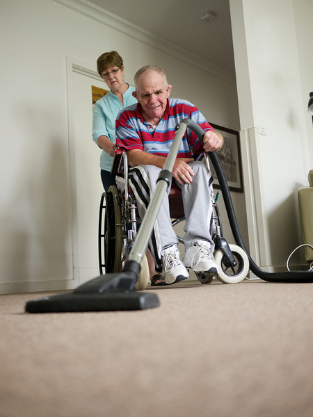 This photo shows a senior man with an intellectual and physical disability vacuuming the floor of his home.  He is being assisted by a home carer.

This photo can be used to illustrate the importance of promoting engagement in meaningful activity.  This whole concept and practice has been referred to as Person-Centred Active Support and has extensive empirical evidence to support its importance in promoting a great quality of life for all people with a disability, “irrespective of degree of disability or the presence of extra problems*

* Mansell, J., Beadle-Brown, J., Ashman, B., & Ockenden, J. (2004). Person-Centred Active
Support. Pavilion Publishing (Brighton) Ltd..