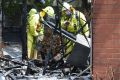 Firefighters survey the damage.