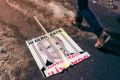 A broken poster depicting the leader of the ruling Social Democrat party Liviu Dragnea, which reads "In a democracy, ...