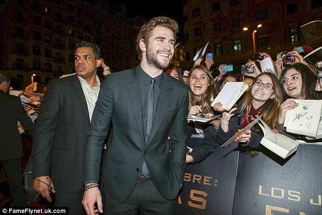 Ronnyc01 looking after Liam Hemsworth at the Madrid premiere of The Hunger Games: Catching Fire 