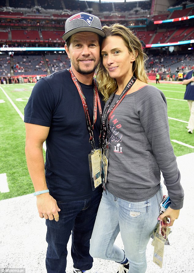 Access all areas: Mark cuddled up to his wife Rhea Durham on the sidelines