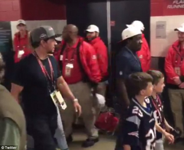 In a rush: Patriots fan Mark Wahlberg was caught leaving after the third quarter by a videographer at the Super Bowl on Sunday