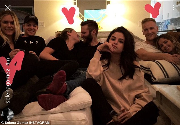 Third wheel: Selena Gomez, 24, flew solo for Super Bowl Sunday, though she was surrounded by friends. The dark-haired diva is currently dating The Weeknd, 26