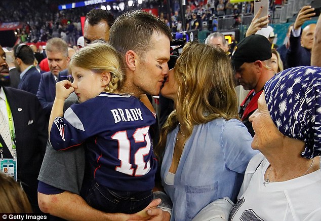 Victory smooch: Gisele Bundchen congratulated Tom Brady with a kiss after he won the big game at Super Bowl LI on Sunday