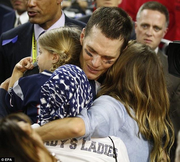 Warm welcome: Tom hugged Vivian, Gisele and his mother at the same time just after this historic win